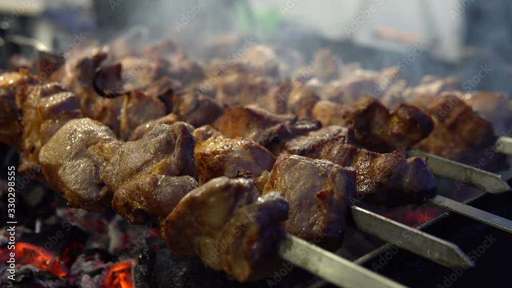 Fresh meat on a steel skewer in a smoke at brazier, diagonal arrangement, selective focus place for text, appetizing food at food court Fresh meat on a steel skewer in a smoke at brazier, diagonal arrangement, selective focus place for text, appetizing food at food court