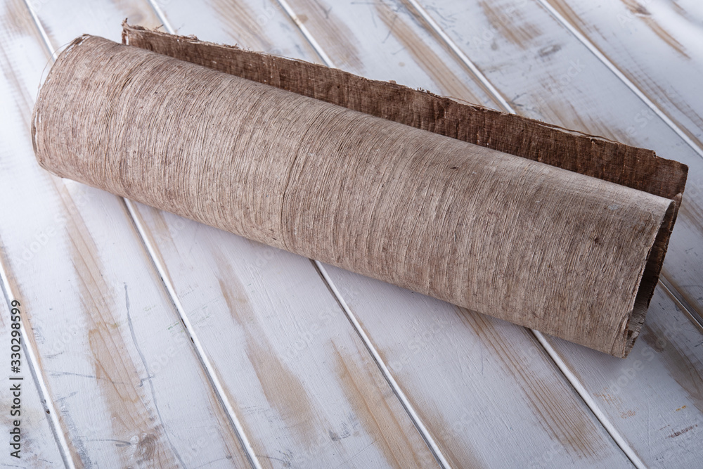 Rolled up papyrus on a white table Rolled up papyrus on a white table
