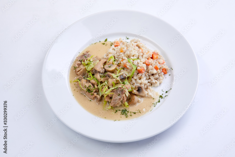 meat with vegetables and barley on the white background