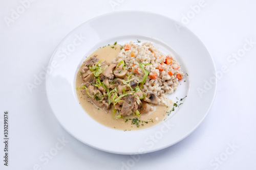 meat with vegetables and barley on the white background