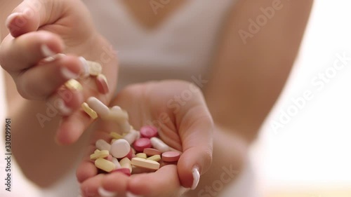 Medical tablet/ aspirins being shown in hand by a lady photo