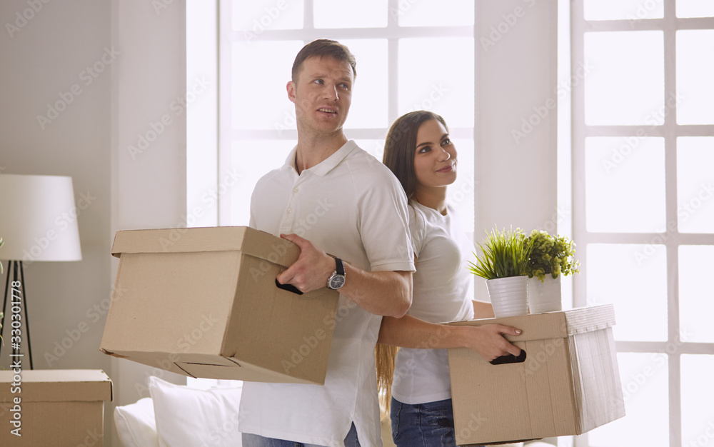 happy Young couple moving in new home happy Young couple moving in new home
