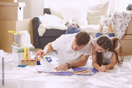 Young Hispanic couple looking at blueprints of new home, high angle view © lenetsnikolai