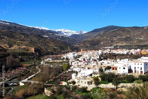 View of the white village of Cadiar with the snow capped mountains of the Sierra Nevada to the rear, Cadiar, Spain. © arenaphotouk