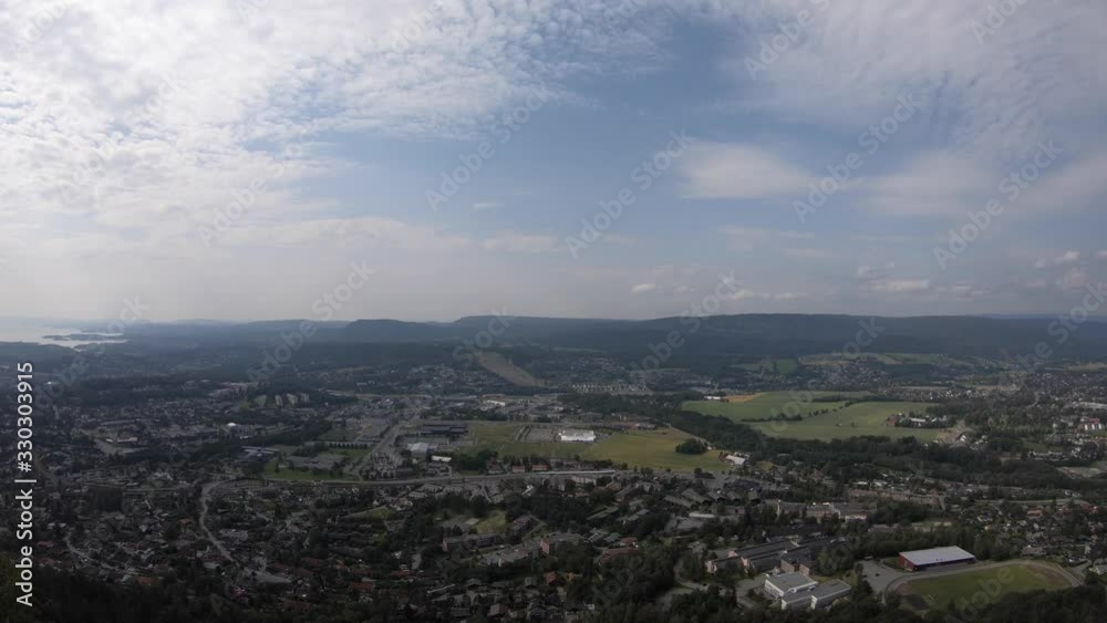 Panorama View on Hike on a Mountain in Norway with View of Tiny Town Near Cliff Edge, Outside of Oslo on a Beautiful Sunny Day Panorama View on Hike on a Mountain in Norway with View of Tiny Town Near Cliff Edge, Outside of Oslo on a Beautiful Sunny Day