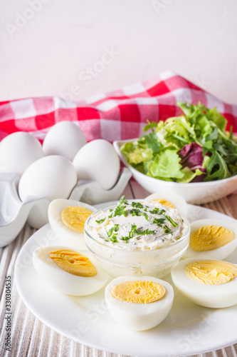 boiled chicken eggs on a white wooden rustic background