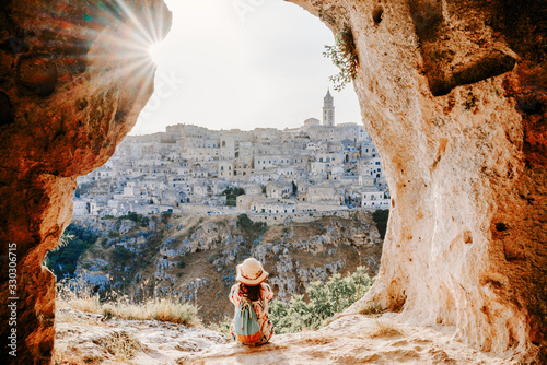 Admiring sunset from a grotto cave on Sassi di Matera, Basilicata, Italy. photo