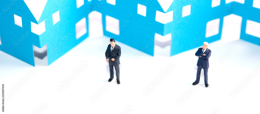 miniature figure of business team work stand in front of paper cutting house. Home loan concept miniature figure of business team work stand in front of paper cutting house. Home loan concept