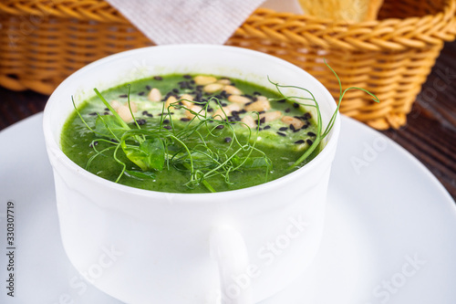 broccoli spinach cream soup on rustic wooden background