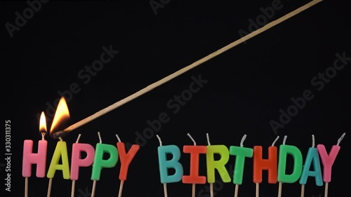 Party Celebration with candles. Lighting candles with happy birthday letters with a long match.