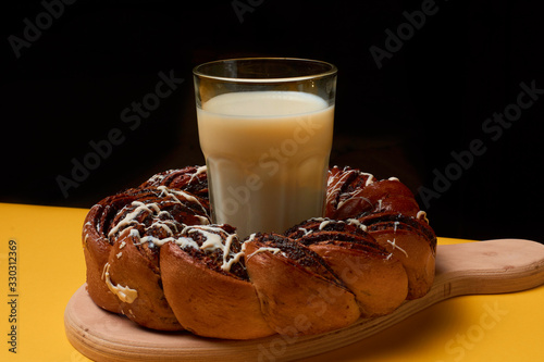 Braided roll with poppy seeds and milk photo