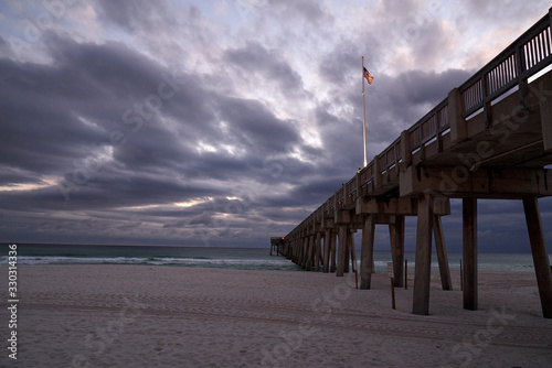 Scenic View of Panama City Florida Pier at sunset with Flag on Pier  © Kenyatta Russell 