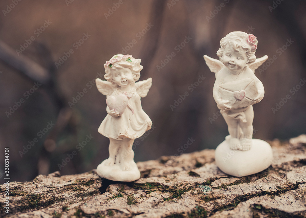 Fototapeta premium two angels on a wooden background