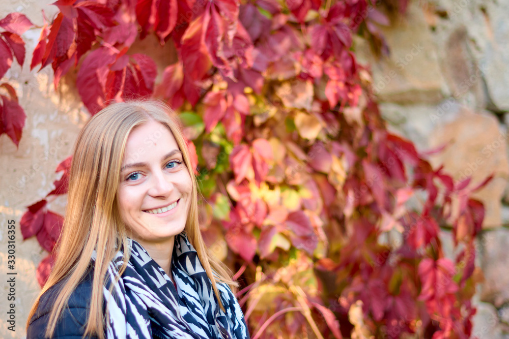 Beautiful young woman is walking in the park. Young woman enjoying nature