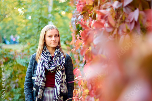 Beautiful young woman is walking in the park. Young woman enjoying nature