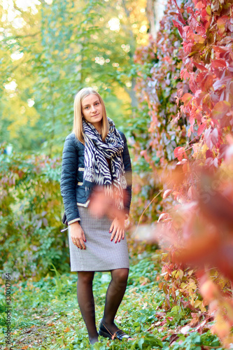 Beautiful young woman is walking in the park. Young woman enjoying nature