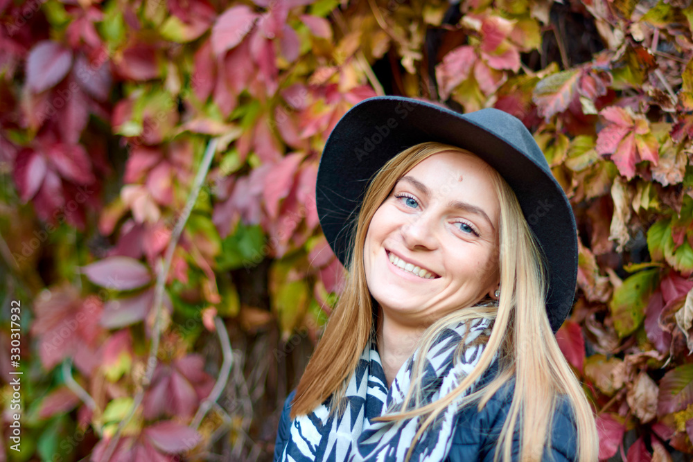 Beautiful young woman is walking in the park. Young woman enjoying nature