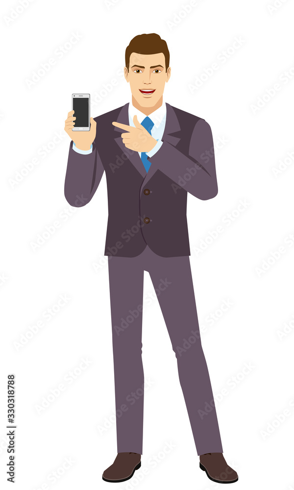 Smiling Businessman pointing at a mobile phone. Full length portrait of Businessman in a flat style. Smiling Businessman pointing at a mobile phone. Full length portrait of Businessman in a flat style.
