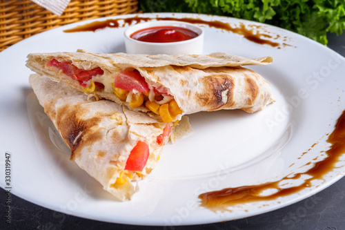 pita meat roll with chicken meat tomato cheese and corn