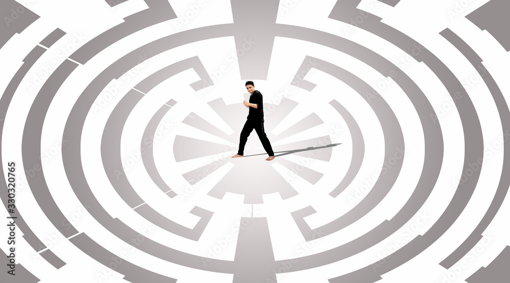 Minimal people: Young man standing on center of maze. Concepts of finding a solution, problem solving and challenge. Minimal people: Young man standing on center of maze. Concepts of finding a solution, problem solving and challenge.