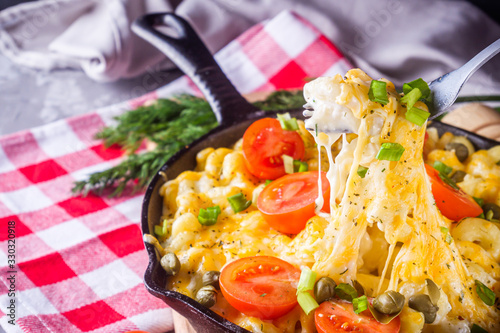 delicious pasta and cheese casserole in a cast iron skillet photo