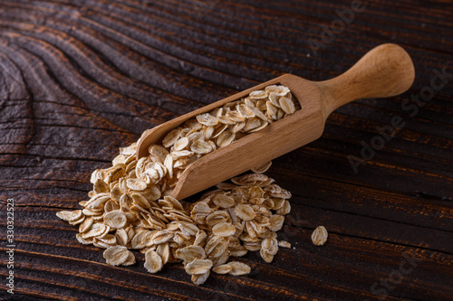 raw oatmeal on a wooden rustic background