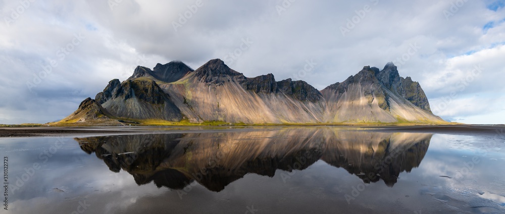 Fototapeta Beautiful shot of a mountain reflected on the water in Stokksnes, Iceland
