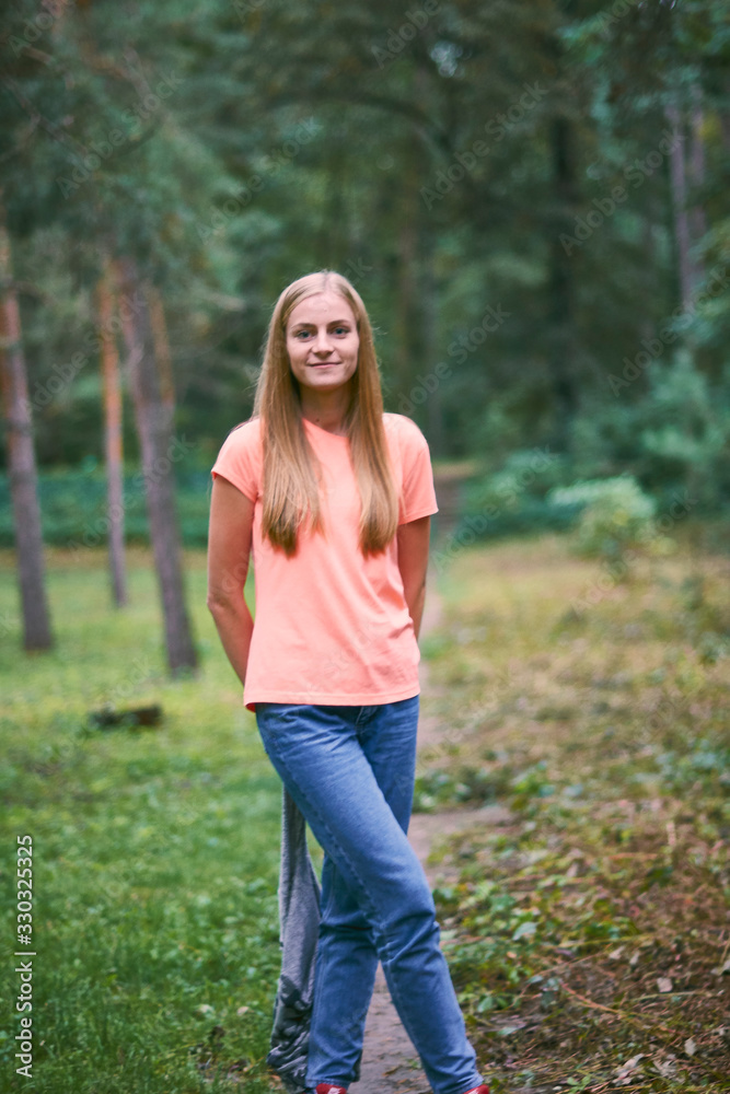 Beautiful young woman walks in the park Beautiful young woman walks in the park