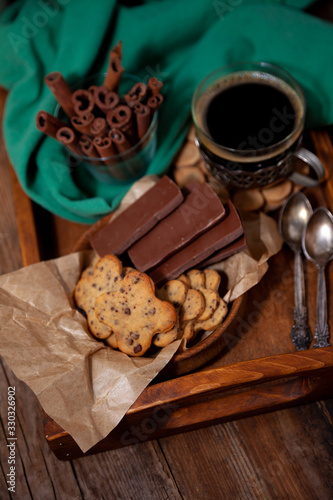 Homemade chocolate chip cookie. Baking, sweet snack. Food on a wooden table. Rustic style. Cooking at home. Chocolate for coffee.