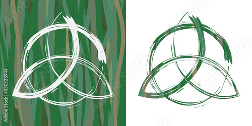 Two options of celtic pagan symbol triquetra on grass background photo