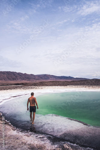 Man walking into beautiful lagoon