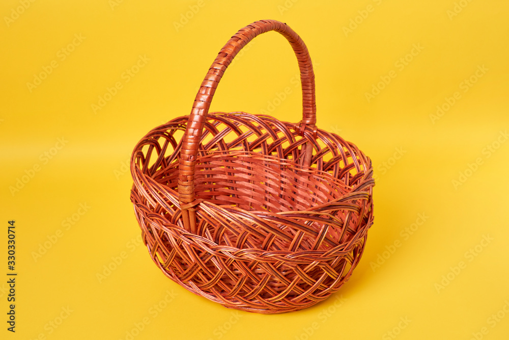 Brown basket in yellow background Brown basket in yellow background