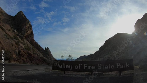 4K. Ultra HD. Entrance sign of the National Park to Valley of Fire in Nevada, towards public lands. Panoramic view of the main road towards the Valley of Fire.