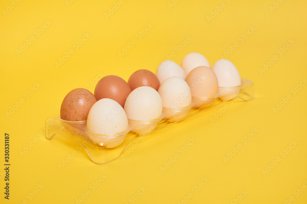 Eggs on a yellow background. Chicken eggs on a wooden board Eggs on a yellow background. Chicken eggs on a wooden board