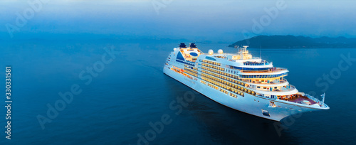 Aerial view of beautiful white cruise ship above luxury cruise in the ocean sea at early in the morning time concept smart tourism travel on holiday vacation time on summer, webinar banner  forwarder  photo