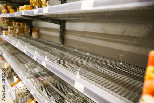 empty shelves with few canned goods left in a Eurpean supermarket because of panic shopping because of Covid-19 virus