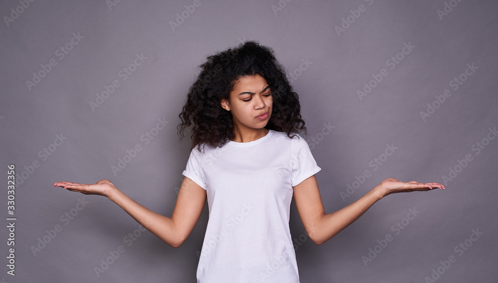Surprised young dark-skinned girl makes a choice, doubts. Surprised young dark-skinned girl makes a choice, doubts.