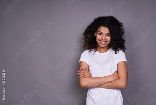 A sympathetic African woman crossed her arms on her chest.