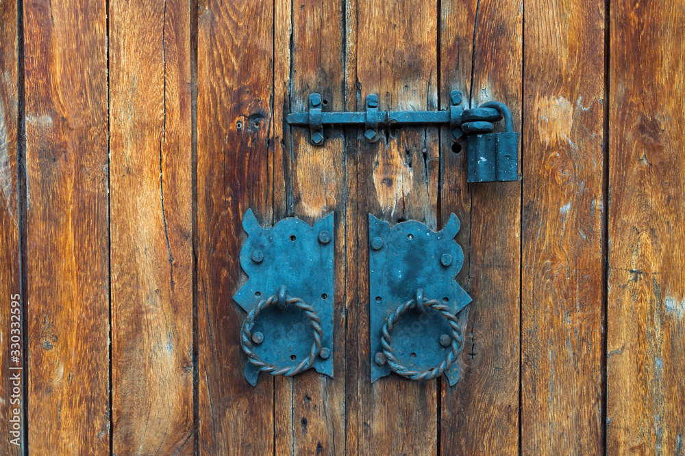 Old wooden door or gate with rusty padlock close up. Old wooden door or gate with rusty padlock close up.