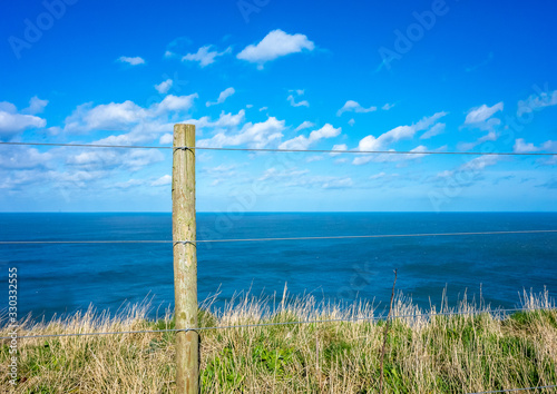 Left hand fence post with seascape