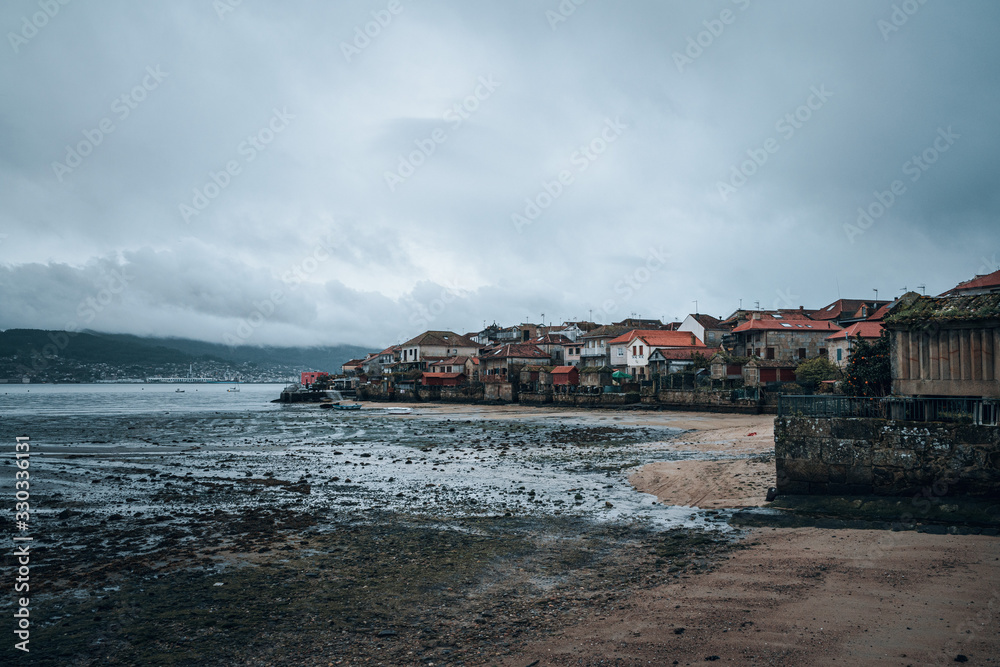 Scenic view of the village of Combarro at low tide against cloudy sky  #330336131 - FotoObrazy