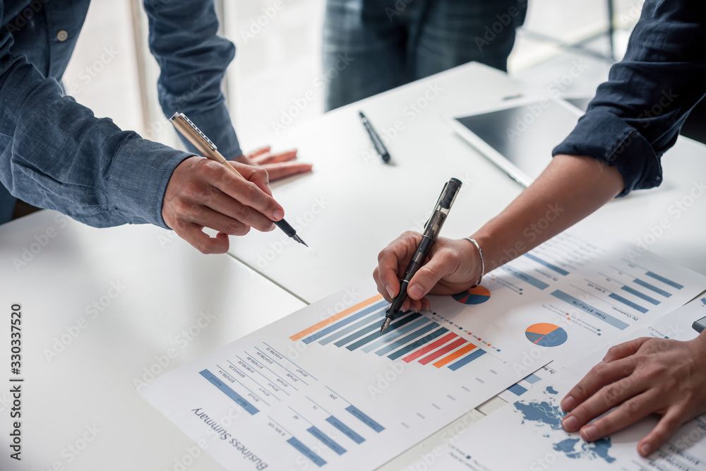 Group of business people meeting together Pointing to the graph assess business profits. Group of business people meeting together Pointing to the graph assess business profits.