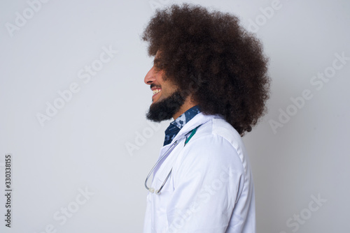Profile of smiling doctor woman with healthy pure skin, has contemplative expression, ready to have outdoor walk, isolated over white studio wall with copy space.