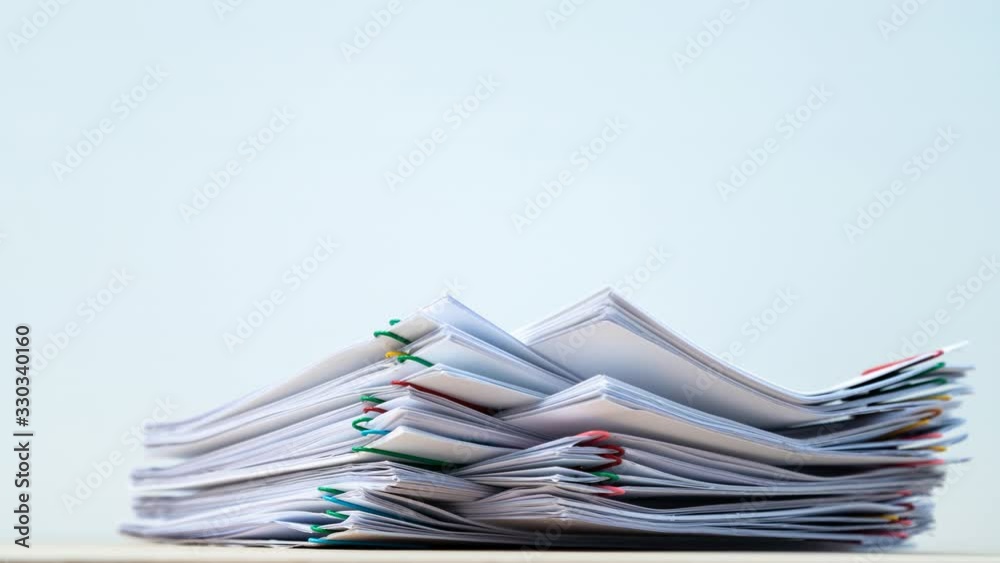4K-Businessman hands working in stacks of paper files for searching information on work desk office, Business report papers concept. 4K-Businessman hands working in stacks of paper files for searching information on work desk office, Business report papers concept.