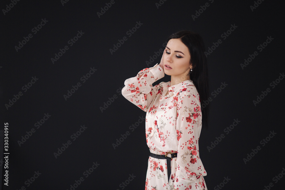 Young brunette model demonstating spring clothes in studio Young brunette model demonstating spring clothes in studio