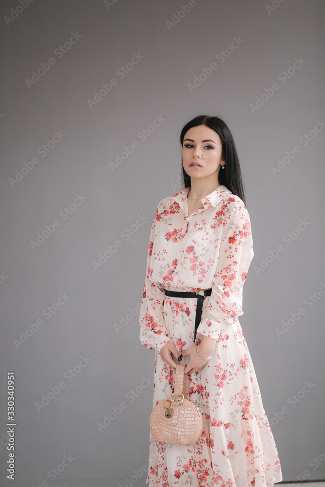 Young brunette model demonstating spring clothes in studio Young brunette model demonstating spring clothes in studio