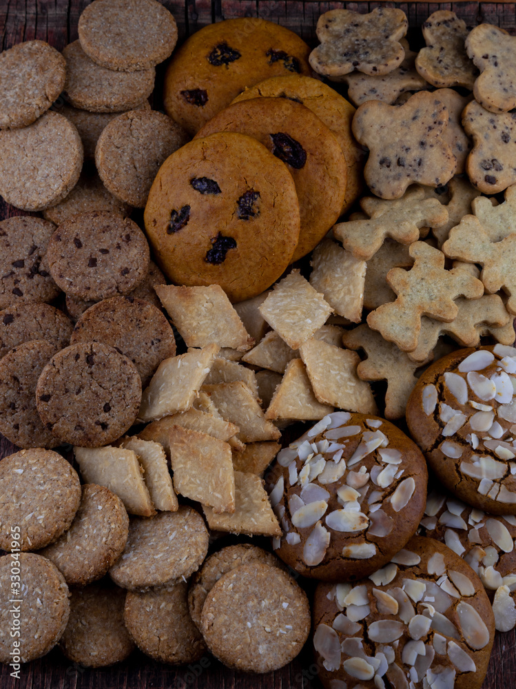 A set of different homemade cookies. Cookies close-up. Background from delicious pastries. Cookie with coconut, mishdal, chocolates, raisins, lingonberries. Round, rhombuses, bears, flowers shapes. A set of different homemade cookies. Cookies close-up. Background from delicious pastries. Cookie with coconut, mishdal, chocolates, raisins, lingonberries. Round, rhombuses, bears, flowers shapes.