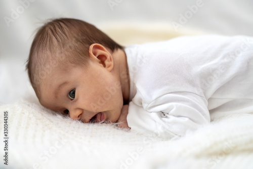 A baby lying on a bed