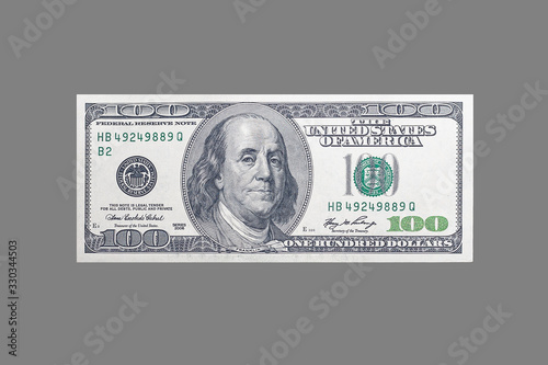 USA money - 100 dollars with a portrait of American President Franklin on an isolated neutral gray background