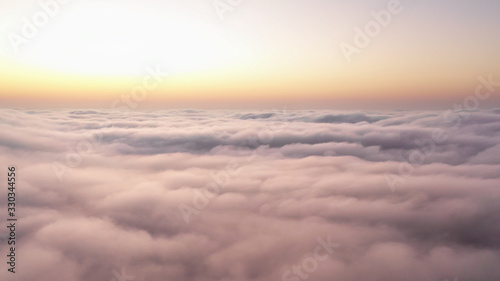 Aerial view of a drone flying above fog clouds in Empty Quarter. Liwa desert, Abu Dhabi, United Arab Emirates.